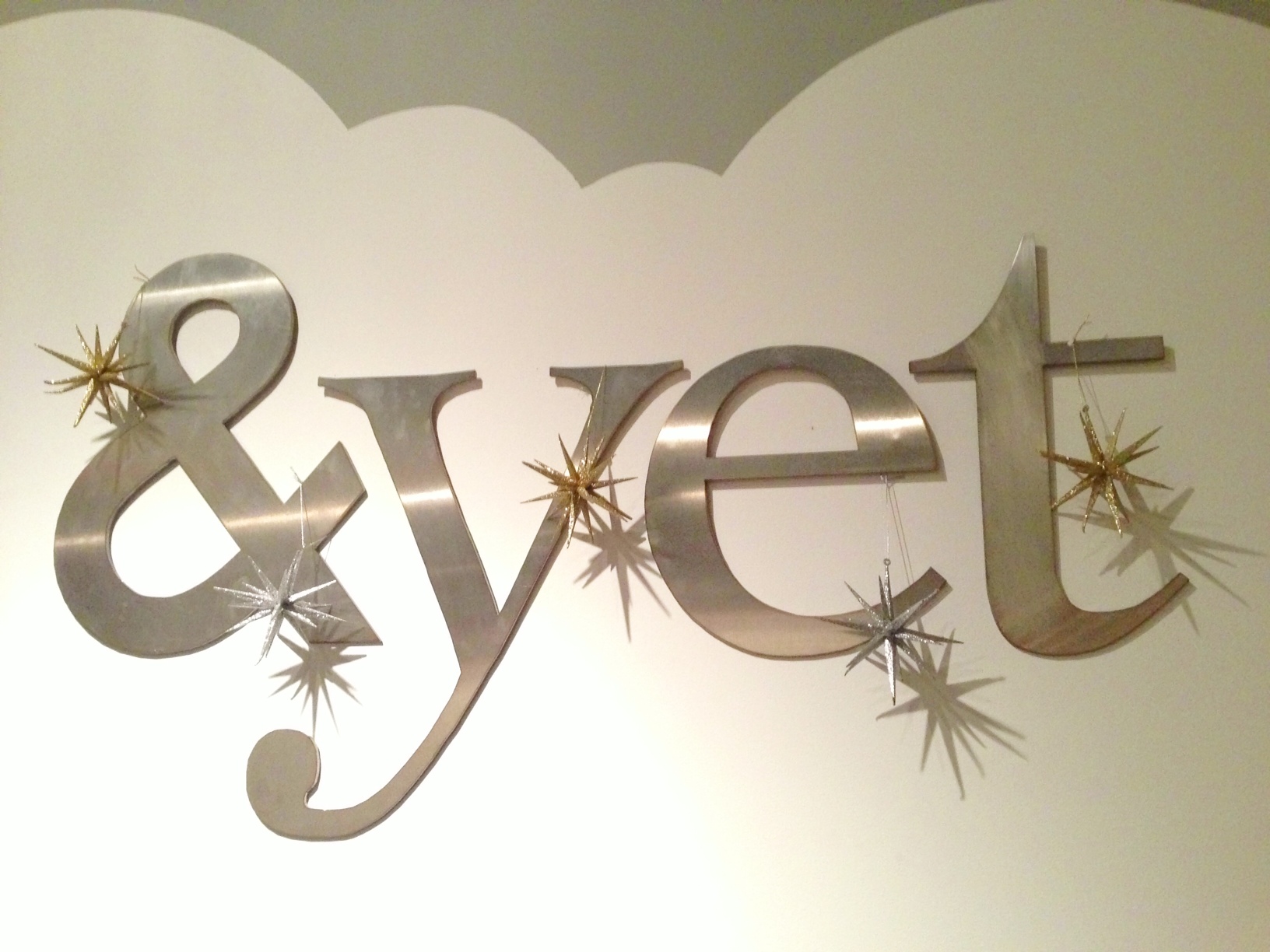 the &yet office logo decorated with ornaments
