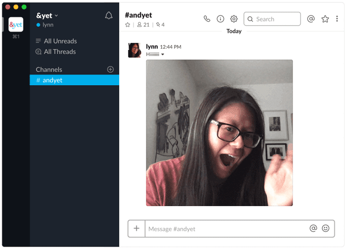Slack chat with a looping gif of a woman smiling and waving.