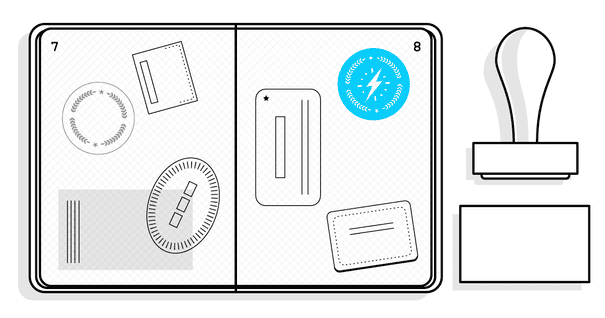 an open passport with plenty of stamps next to a stamp and inkpad