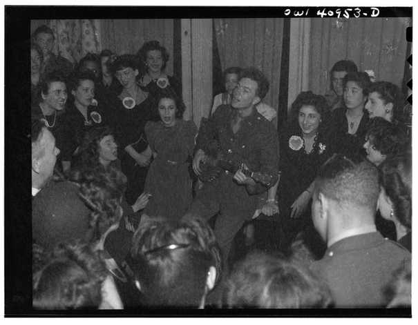 Pete in Army uniform surrounded by people singing, 1941